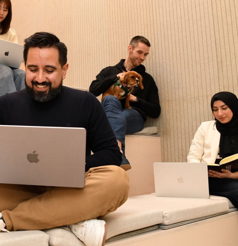 A group of Rokt interns working on their laptops